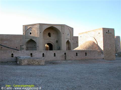 Mud-brick caravanserai with arched gateway in the Iranian desert