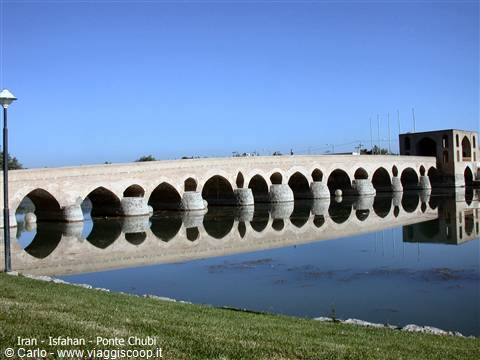 Khaju Bridge in Isfahan, brick arches reflected in the Zayandeh river under blue sky