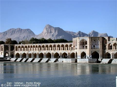 Khaju Bridge in Isfahan, brick arches over the river with arid mountains