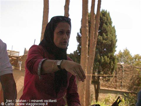 Woman in black headscarf pointing at the shaking minarets of Isfahan