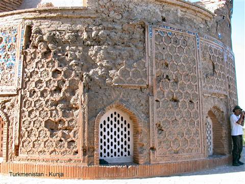 Tourist photographing the hexagonal tiled brick mausoleum in Kunya-Urgench