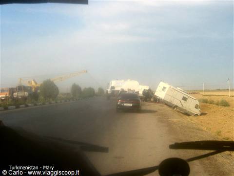 Overturned camper van on the dusty roadside in Mary, Turkmenistan