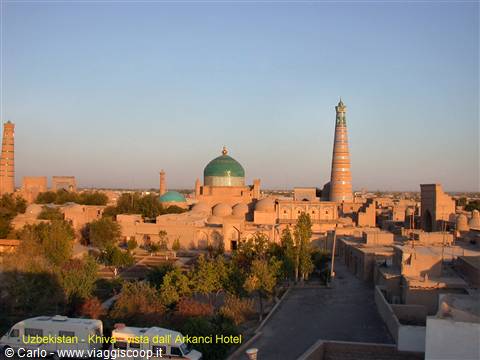 Khiva: green dome and brick minaret at sunset