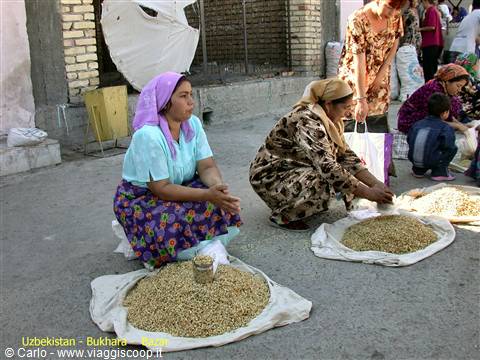 Women in headscarves selling grains at Bukhara market