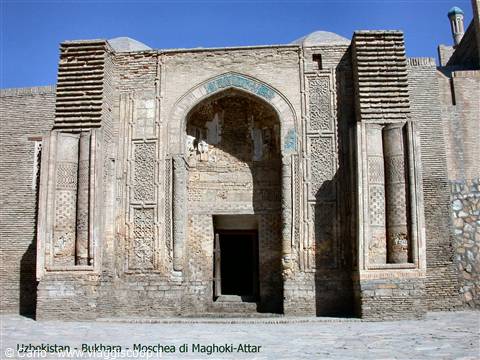 Brick facade of Maghoki Attar mosque in Bukhara under bright sunlight