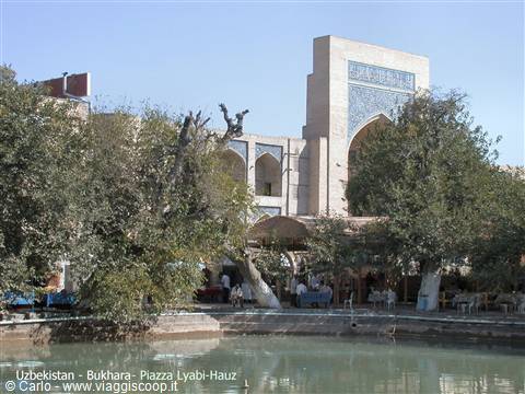 Bukhara, Lyabi-Hauz square: brick portal and trees around the pond
