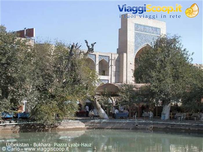 Bukhara, Lyabi-Hauz square: brick portal and trees around the pond