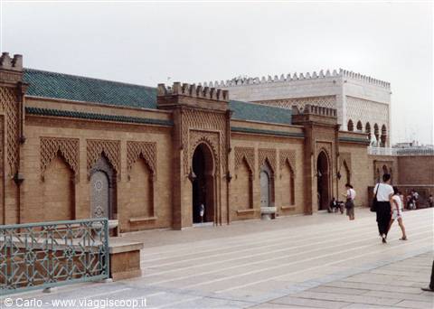 Tourists walk past the arches of Mohammed V Mausoleum in Rabat