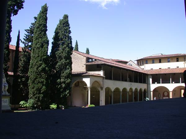 Cloister with arches and cypresses, Santa Maria Novella, Florence, sunlight