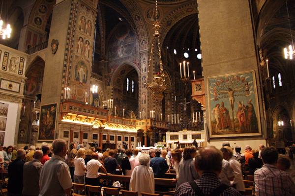 Worshippers standing among the pews inside Padua's Basilica of Saint Anthony