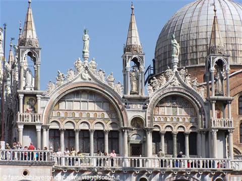 St Mark's Basilica in Venice: marble spires, golden mosaics and tourists on terrace