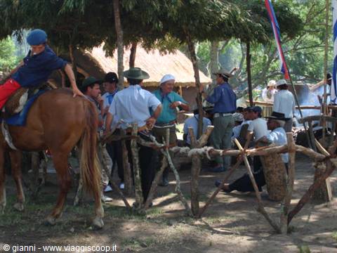 The members of a 'Sociedad Tradicionalista' gathered in the reconstruction of a typical 'rancho'