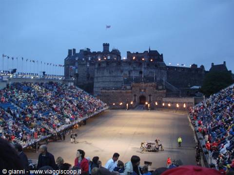 Edinburgh Castle esplanade at dusk, packed grandstands during the Military Tattoo