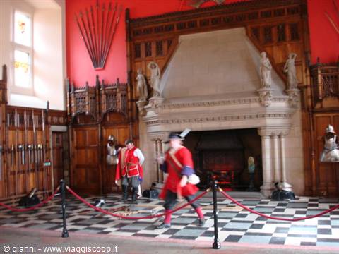 Guards in red uniforms inside Edinburgh Castle's Great Hall