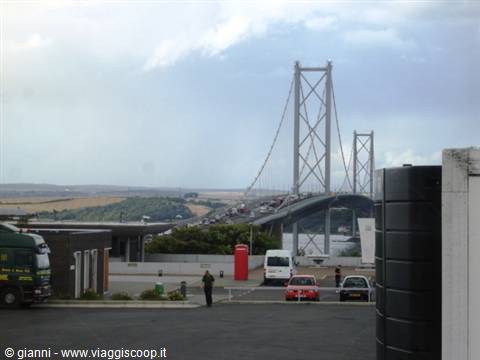Forth Road suspension bridge, heavy traffic, parked cars under a cloudy sky