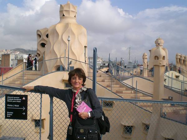 Woman on La Pedrera rooftop in Barcelona, among Gaudí's sculptures