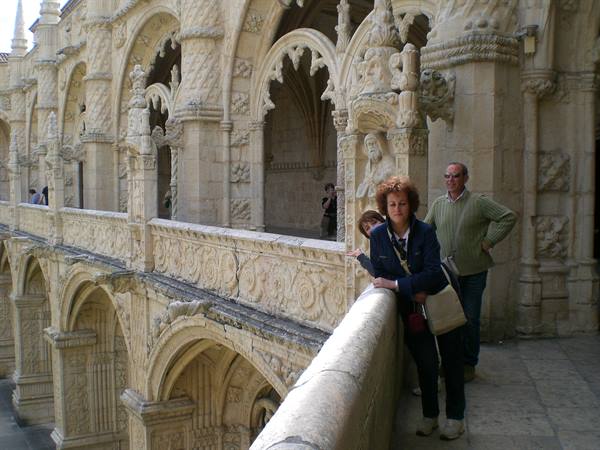 Tourists on the Manueline cloister of the Jerónimos Monastery, carved stone in sunlight