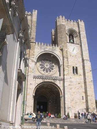 Romanesque stone facade with rose window and towers of Lisbon Cathedral