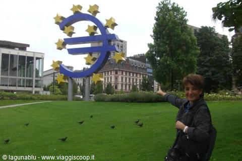 Woman points at the giant euro sculpture outside the European Parliament in Strasbourg