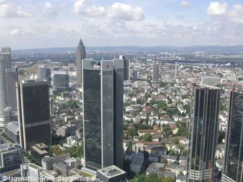 Frankfurt skyscrapers from above, dark glass Trianon tower under white clouds