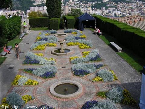 Garden with stone fountains and flower beds overlooking Monaco