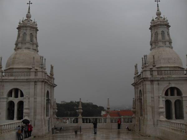 Two baroque stone towers on the roof of São Vicente de Fora monastery, grey sky