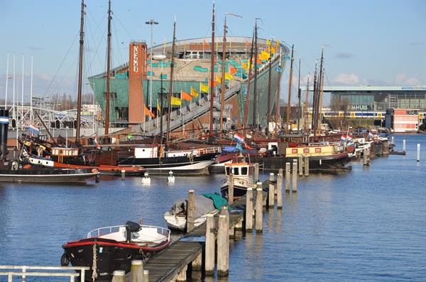Historic boats moored at the pier in front of the NEMO museum, Amsterdam
