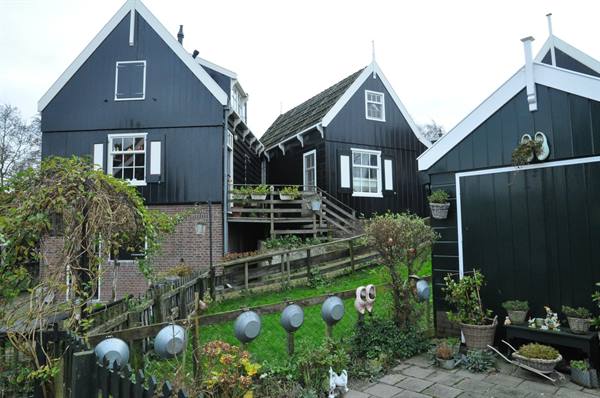 Black wooden houses with white trim and garden, Zaanse Schans
