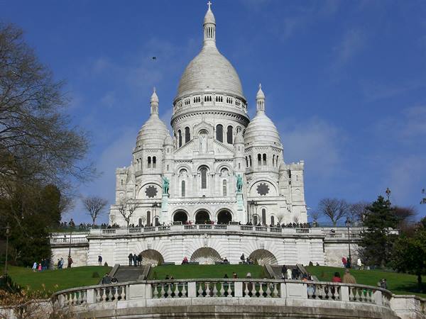 Tourists on the steps of the Sacré-Cœur in Montmartre on a sunny day