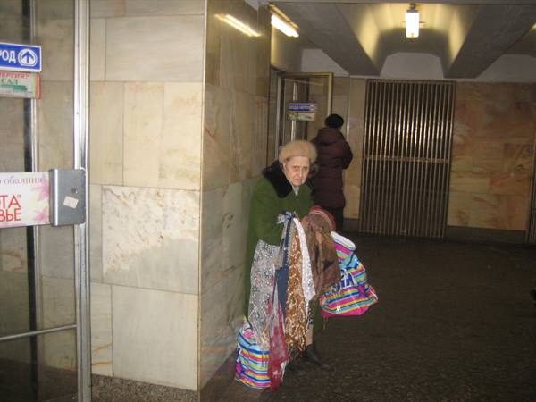Elderly vendor in the metro