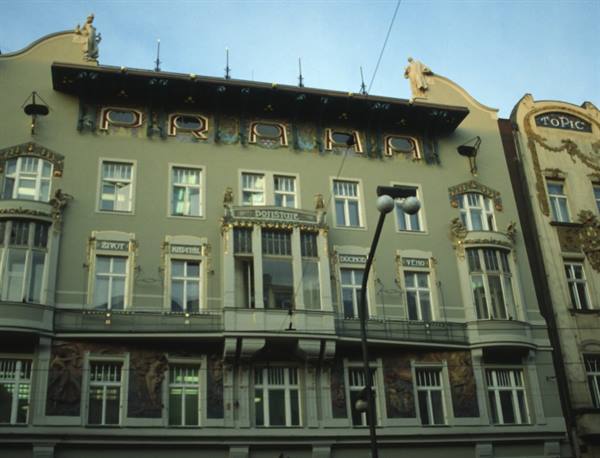 Art Nouveau facade with golden Praha sign, morning light, Prague
