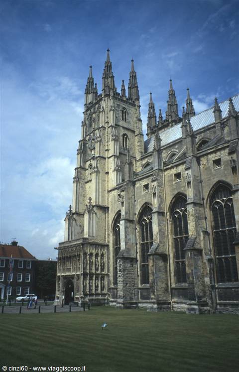 Canterbury Cathedral, Gothic stone pinnacles and arched windows under cloudy sky