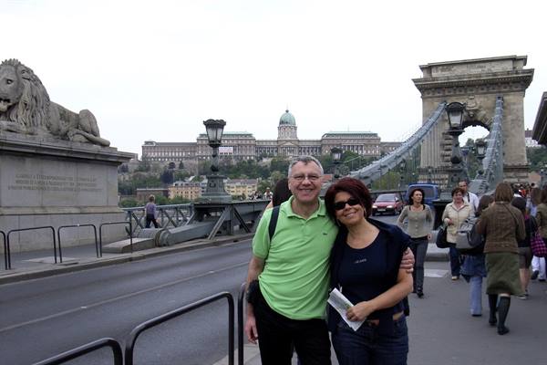 Smiling couple on the Chain Bridge in Budapest, royal palace in the background