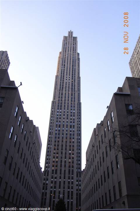 The Rockefeller Center skyscraper rising between stone buildings, New York