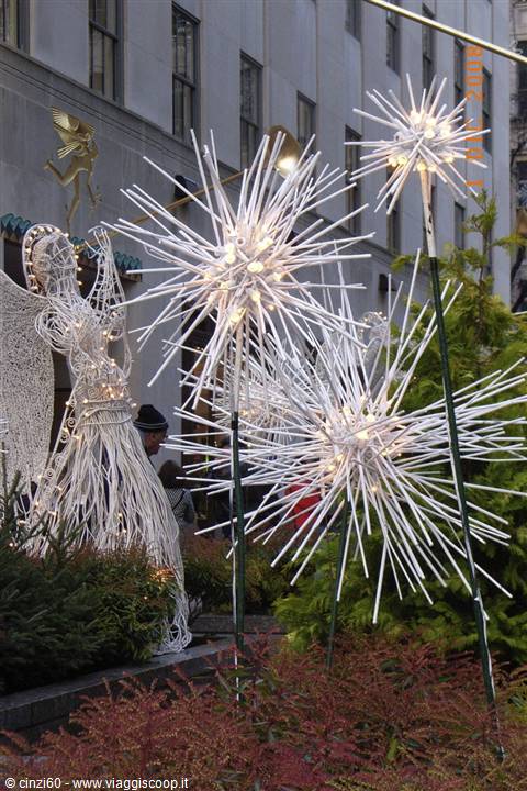 Glowing star sculptures and white wire angel at Rockefeller Center, New York
