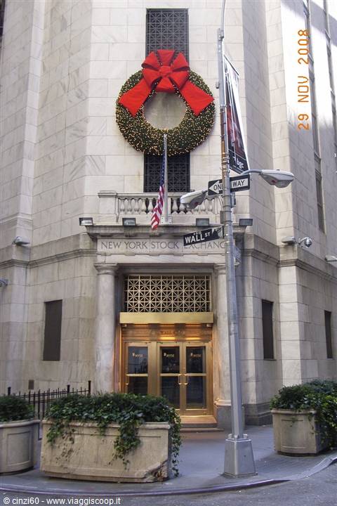 Marble facade of the New York Stock Exchange with Christmas wreath, golden entrance on Wall Street