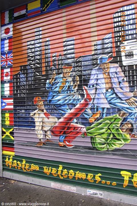 Mural on a shutter in Harlem: hip-hop dancers among skyscrapers and flags
