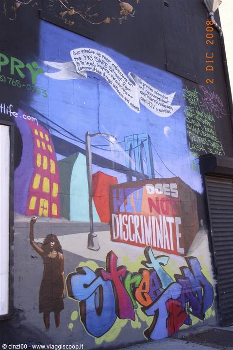 New York mural: painted bridge, woman raising fist, HIV does not discriminate message