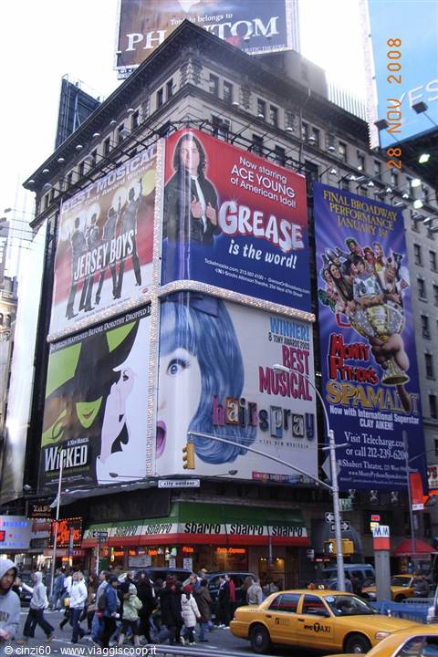 Times Square, New York: Broadway musical billboards above crowds and yellow taxis