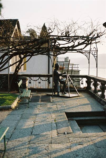 town hall park with a statue of a painter portraying the lake