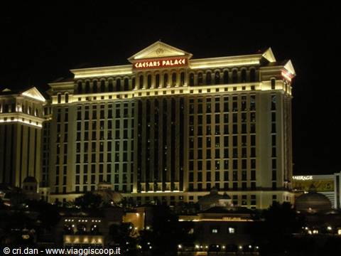 Caesars Palace hotel lit up at night in Las Vegas, golden facade
