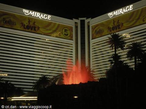 The Mirage volcano erupts at night with orange flames, Las Vegas