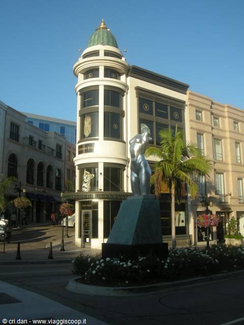 Silver statue in front of the green-domed store on Rodeo Drive