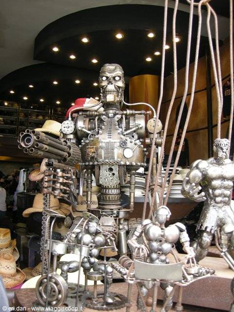 Recycled metal robot sculptures, a Terminator, displayed in a hat shop