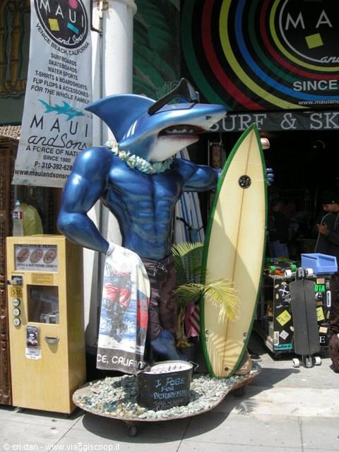 Muscular shark statue with surfboard outside the Maui and Sons surf shop