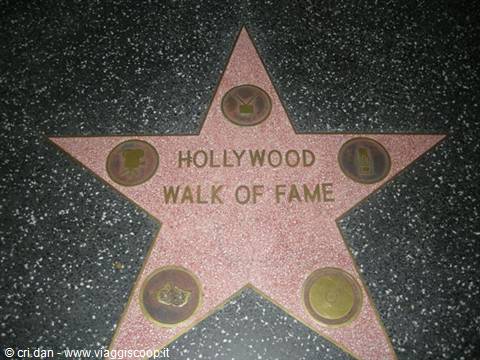 Pink terrazzo star reading Hollywood Walk of Fame on the Los Angeles sidewalk