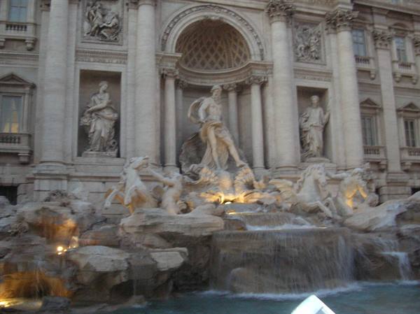 Trevi Fountain in Rome: Oceanus statue among marble horses, evening light