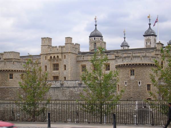 Tower of London, stone walls and turrets under a cloudy sky