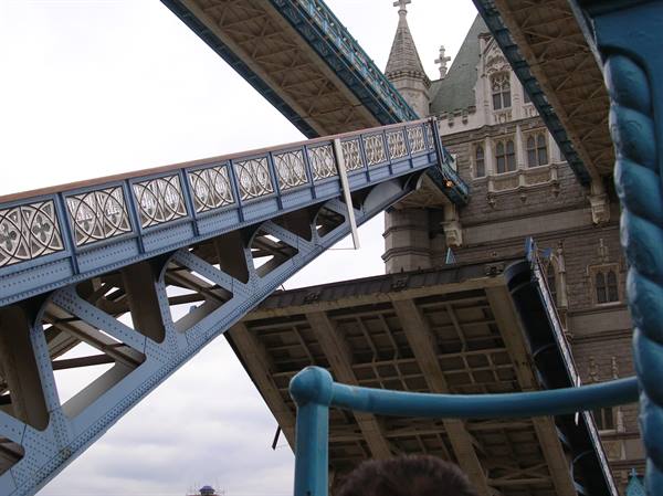 Tower Bridge: the steel bascule rising beneath the Gothic stone tower