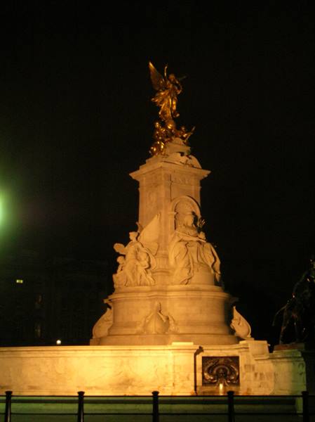 Marble Victoria Memorial lit at night, golden angel statue on top